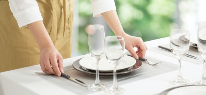 A housekeeper doing table setting