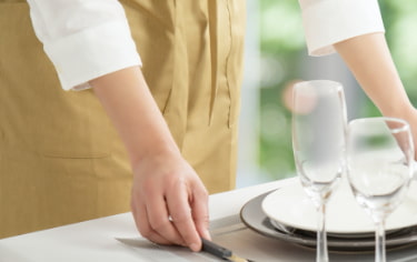 A housekeeper doing table setting