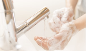 A housekeeper washing her hands