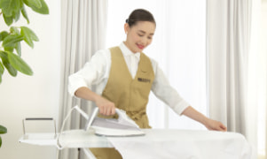 A housekeeper ironing clothes